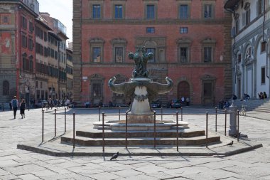 Florence, Italy - April 01 2019: One of the two fontane dei mostri marini (Fountains of sea monsters) in the Santissima Annunziata plaza. Inaugurated in 1641 by artist Pietro Tacca. clipart