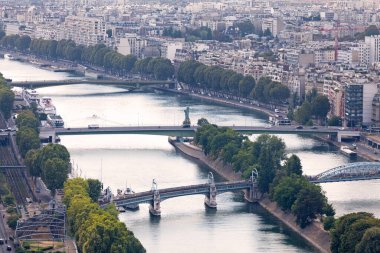 Paris, France - September 01 2016: View downstream of the Seine from the Eiffel Tower, showing, from bottom to top, the Pont Rouelle, the Pont de Grenelle (with the replica of the Statue of Liberty) and the Pont Mirabeau. clipart