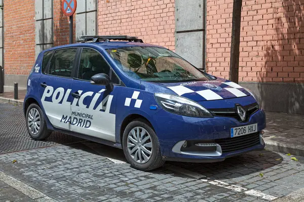 Stock image Madrid, Spain - June 06 2018: A blue police car from the Municipal police (Spanish: Policia municipal) parked outside of a police station.