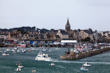 Roscoff, Fransa - 22 Temmuz 2017: Batz Adası 'ndan feribot Roscoff Limanı' na giriyor, arkasında da Eglise Notre-Dame de Croaz Batz 'in kulesi bulunuyor..