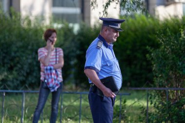 Bükreş, Romanya - 24 Haziran 2018: Piata de Victoriei 'deki kalabalığı izleyen polis.