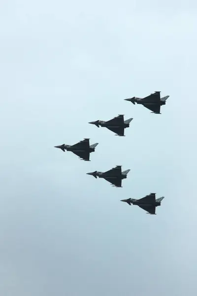 stock image London, England - June 17 2007: Royal Air Force Parade for the Queens Birthday viewed from Battersea Park. The formation is composed of five Typhoon FGR4 flying in arrow formation against an overcast sky.