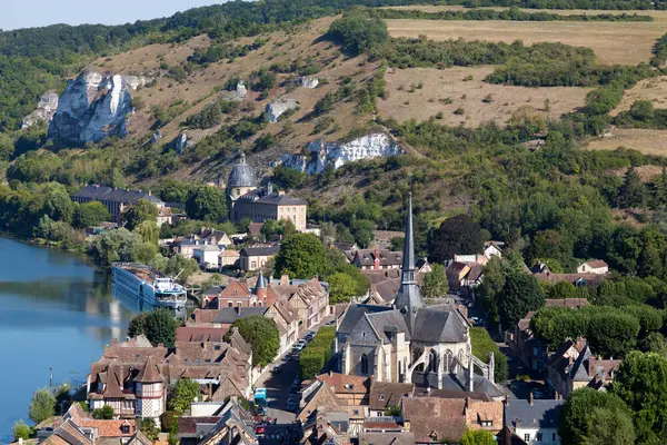 stock image Cityscape of the town of Les Andelys alongside the Seine river with the church of Saint-Sauveur du Petit-Andely in the foreground and the Saint-Jacques hospice in the background near the cliffs