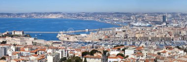 Marseille, France - March 23 2019: Panoramic view of the Vieux Port with the City Hall, the Palais Pharo, the Fort Saint-Nicolas and many other landmarks. clipart