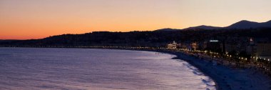 Aerial view at sunset of the Promenade des Anglais in Nice with the Hotel Negresco, the Palais de la Mediterranee and Le Meridien. clipart