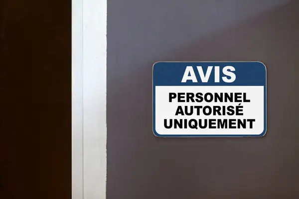 stock image Blue and white notice sign on the side of an open door stating in French : 