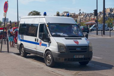 Paris, Fransa - 1 Eylül 2016: Polis memurları devriye gezerken, Eiffel Kulesi 'nin ana girişinden birkaç metre uzakta, Quai Branly' de park halindeki CRS minibüsü.