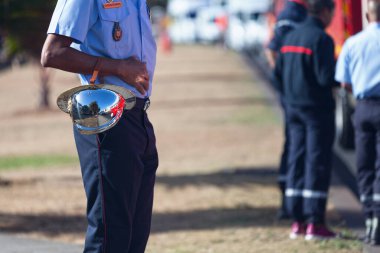 Saint Denis, Reunion - July 14 2016: Sergeant firefighter in ceremonial dress getting ready before the start of the parade of Bastille Day. clipart