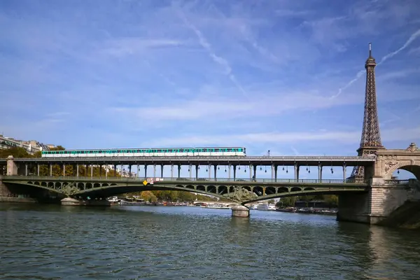 stock image Paris, France - September 23 2017: Subway train passing on the viaduc de Passy (above the Pont de Bir-Hakeim) with the Eiffel Tower behind.