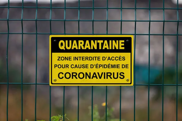 Stock image Red an white warning sign on a fence stating in French  