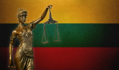 Close-up of a small bronze statuette of Lady Justice before a flag of Lithuania. clipart