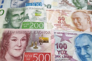 Close-up on a stack of Swedish krona and Turkish lira. clipart