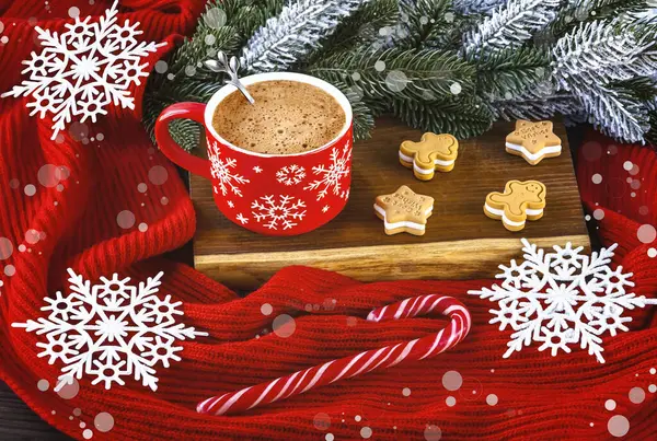 Red cup of coffee with snowflakes, gingerbread, lollipop, Christmas tree branches, red woolen scarf. Festive Christmas composition