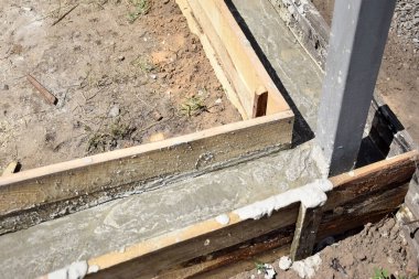 Wooden formwork concrete strip foundation for a veranda in a house. Outdoor construction work.