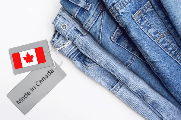Detail of blue jeans, label and Made in Canada lettering. The concept of buying, selling, shopping and trendy modern clothes.