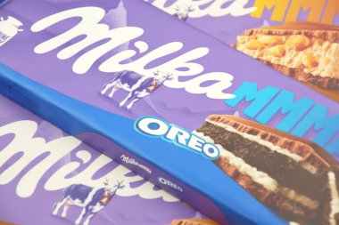 KHARKIV, UKRAINE - 12 Şubat 2023: Oreo aromalı çikolatalı Milka ve yumuşak pembe arkaplanda karamel.
