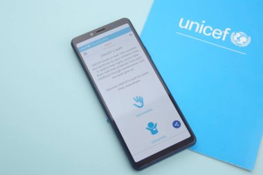 KHARKIV, UKRAINE - FEBRUARY 12, 2023: Unicef logo on the flyer. UNICEF is a United Nations program that provides humanitarian and developmental assistance to children and mothers in developing countries.
