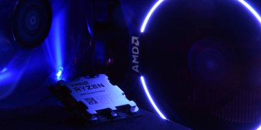 UKRAINE, KHARKIV, NOVEMBER 14, 2022: Close-up of an AMD Ryzen 9 7900X processor, against the backdrop of coolers with light.