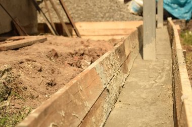 Wooden formwork concrete strip foundation for a veranda in a house. Outdoor construction work.
