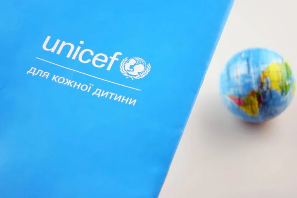 stock image KHARKIV, UKRAINE - FEBRUARY 12, 2023: Unicef logo on the flyer, is a United Nations program that provides humanitarian and developmental assistance to children and mothers in developing countries.