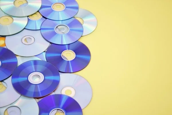 stock image Lots of old CDs are laid out as a background. Bright background. Vintage.