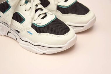 Bright female sneakers on light pink background. Fashion blog or magazine concept. Flat lay top view copy space minimal background.