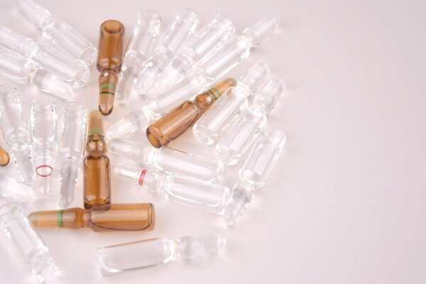 Many medical ampoule on light background. Medicines concept. Vials for medical injection.