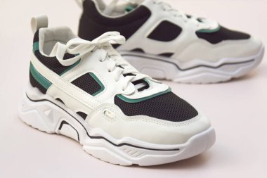 Bright female sneakers on light pink background. Fashion blog or magazine concept. Flat lay top view copy space minimal background.