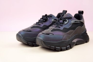 Bright female sneakers on light pink background. Fashion blog or magazine concept. Flat lay top view copy space minimal background.