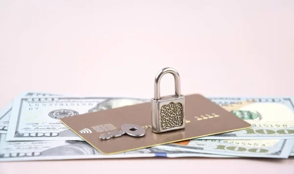 Financial fraud protection concept: credit card, padlock and master key on the light background.