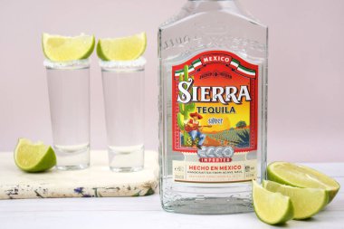 Kharkiv, Ukraine, JULY 11, 2023: Bottle of Sierra tequila on a light background. Tequila is a type of alcoholic drink made from the blue agave plant. clipart