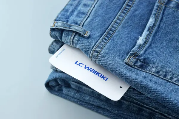 stock image Kharkiv, Ukraine, October 31, 2023: Blue jeans with white tag and LC Waikiki logo.