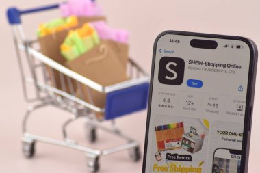 KHARKOV, UKRAINE - August 18,2024: The shopping cart with a smartphone there is Shein app open on the screen. clipart