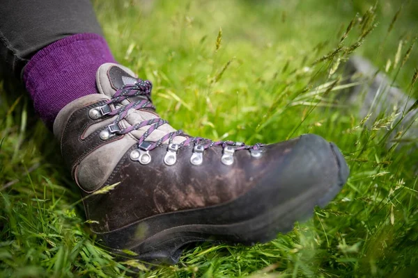 stock image Tying shoelaces on hiking boots by a girl on a hike in spring