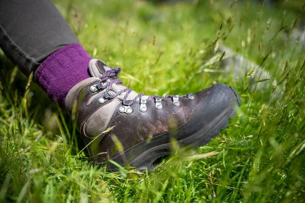 stock image Tying shoelaces on hiking boots by a girl on a hike in spring