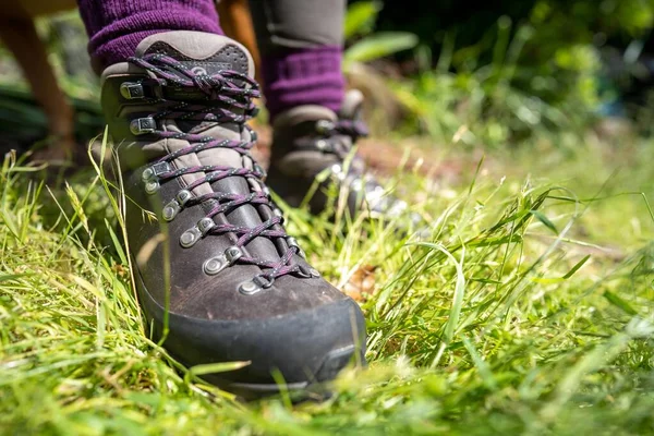 stock image Tying shoelaces on hiking boots by a girl on a hike in spring
