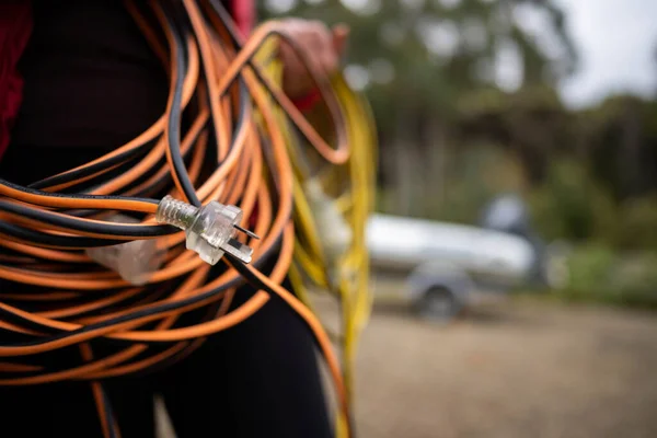 power lead on a building site, electrician with a power cable outside