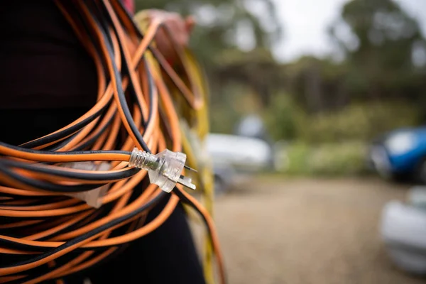 extension cord wrapped up on the ground. extension lead, power lead on a construction site