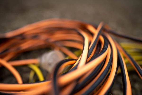 power lead on a building site, electrician with a power cable outside