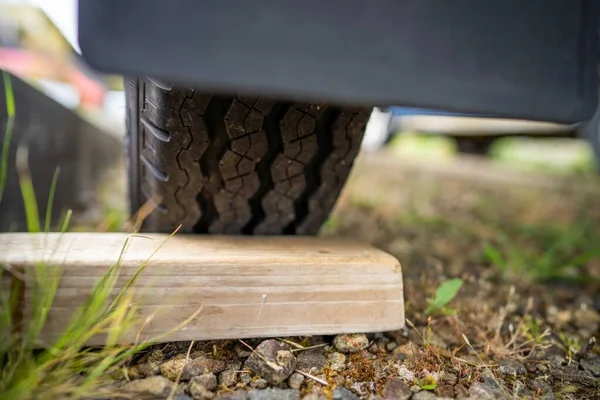 wood chocks for a caravan and camping. chocks behind a tyre. camping chocks for a boat trailer of travellers in australia in summer