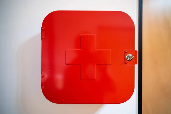 red first aid kit mounted to the wall full of supplies. red first aid kit in australia