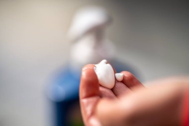 Yazın Avustralya 'da güvertede güneş kremi süren bir kız.