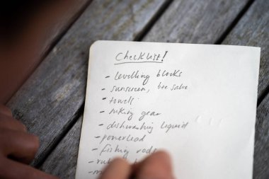 women teacher writing outside. wprking writing notes in a school