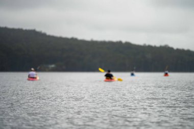 friends going for a kayak on a lake in summer time in america