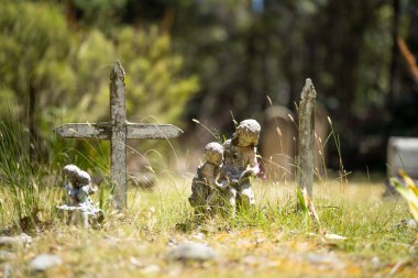 cemetery graves and cross in a graveyard in a church