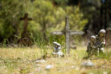 cemetery graves and cross in a graveyard in a church