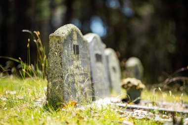 cemetery graves and cross in a graveyard in a church