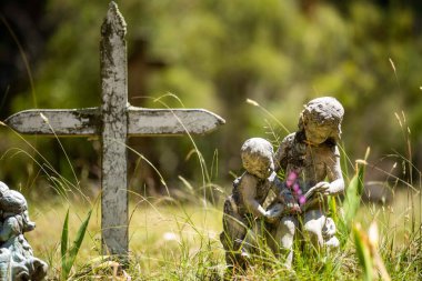 cemetery graves and cross in a graveyard in a church