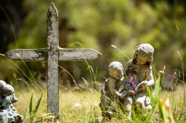 cemetery graves and cross in a graveyard in a church