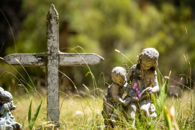 cemetery graves and cross in a graveyard in a church